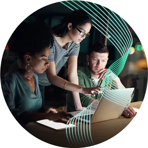Co-workers gathered around a laptop screen.